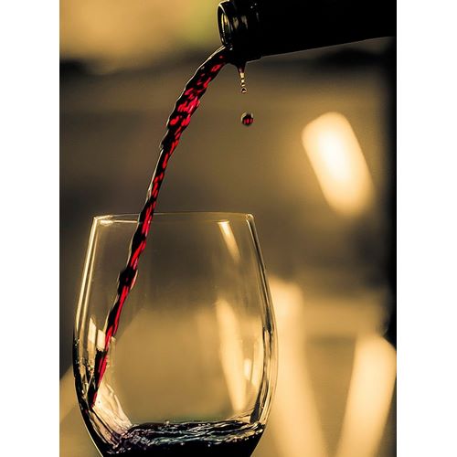 One drop shows as red wine is poured into glass